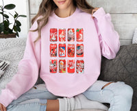 a woman sitting on a couch wearing a pink coca cola sweatshirt