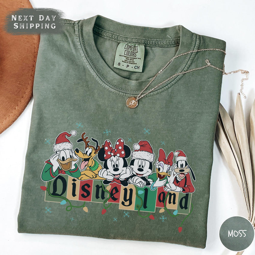 a green shirt with mickey and friends on it