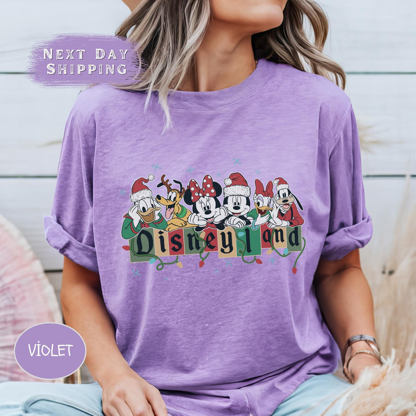 a woman wearing a purple disneyland shirt