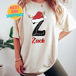 Comfort Colors Custom Christmas Name Shirt with Santa Hat, Personalized Christmas Letter Tee, Cute Holiday Gift for Women, Xmas Lights Shirt