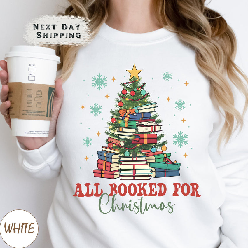 a woman holding a cup of coffee and a christmas tree sweatshirt