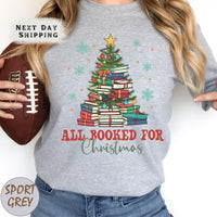 a woman holding a football and a christmas tree shirt