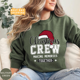 a woman sitting on a couch wearing a christmas crew sweatshirt