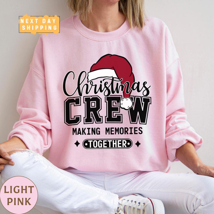 a woman wearing a pink christmas crew sweatshirt