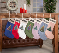 a group of christmas stockings hanging from a rail