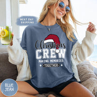 a woman sitting on a couch wearing a christmas crew shirt