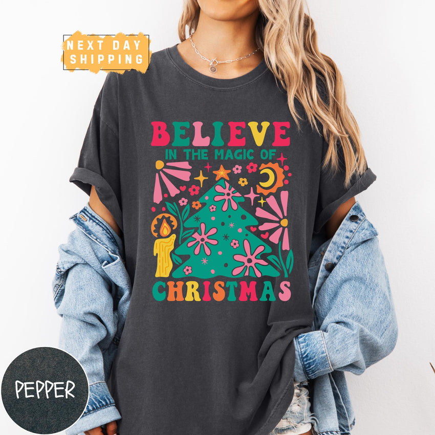 a woman wearing a t - shirt that says believe in the magic of christmas