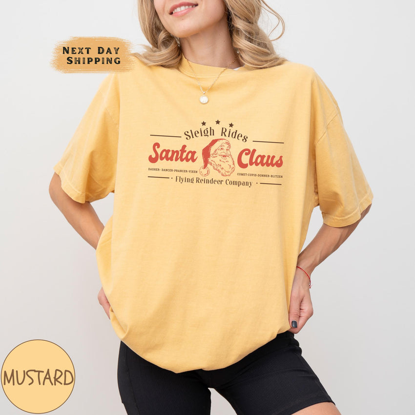 a woman wearing a yellow santa claus t - shirt