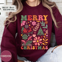 a woman wearing a maroon merry christmas sweatshirt