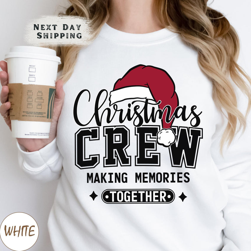 a woman holding a cup of coffee wearing a christmas crew sweatshirt