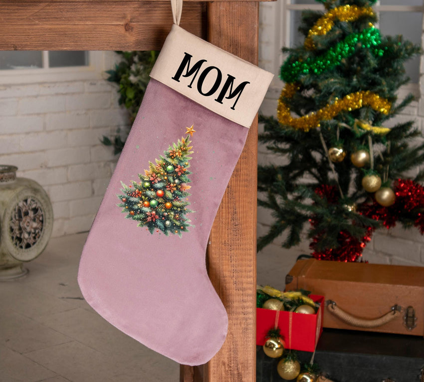 a pink christmas stocking with a christmas tree on it