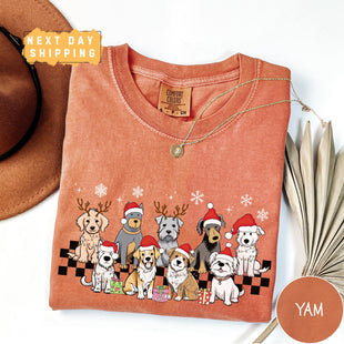 a t - shirt with dogs on it and a hat next to it