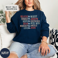 a woman sitting on a couch wearing a navy sweatshirt