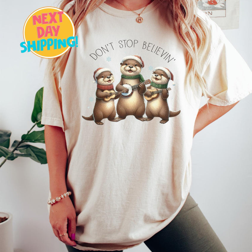 Comfort Colors Don’t Stop Believin Christmas Otter Shirt,  Otters Merry Christmas Shirt, Otter Lover Christmas Gift, Sea Animal Christmas