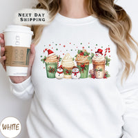 a woman holding a cup of coffee wearing a christmas sweater