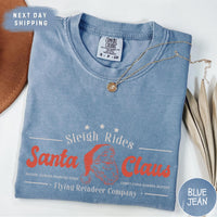 a blue shirt with a santa clause logo on it