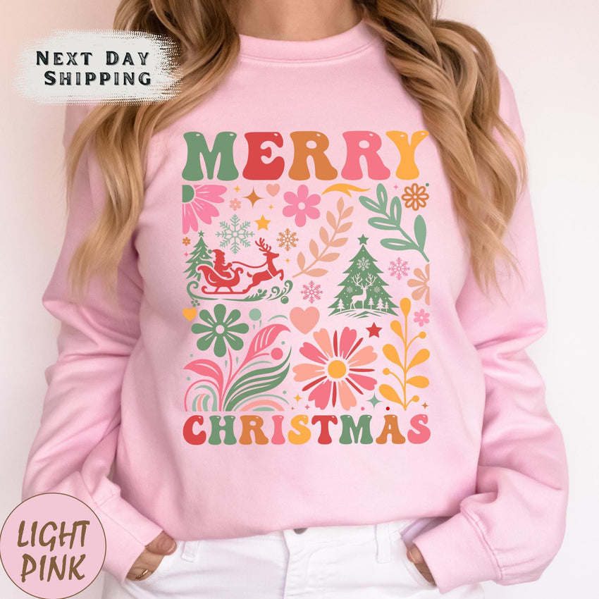 a woman wearing a pink merry christmas sweatshirt