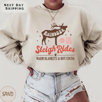 a woman wearing a sweatshirt that says sleigh rides