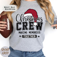 a woman holding a football and wearing a christmas crew shirt